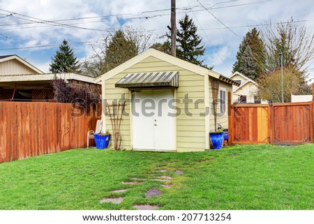 Fenced backyard with small shed