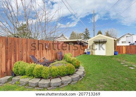 Fenced backyard with shed and landscape design