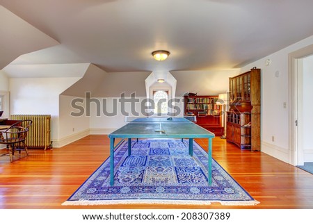 Entertainment room with vaulted ceiling and hardwood floor. View of tennis table