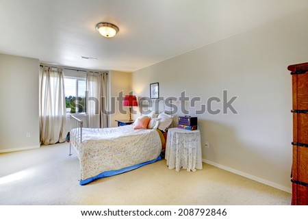 Bright bedroom with window. Furnished with antique iron frame bed