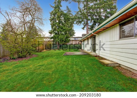 Fenced backyard with small walkout deck