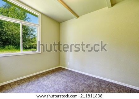 Empty house interior. Small  room with window and brown carpet