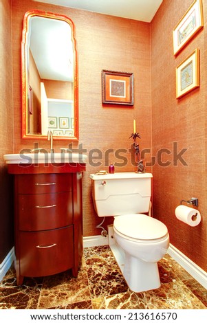 Bright orange bathroom in luxury house with tile floor and wooden washbasin cabinet