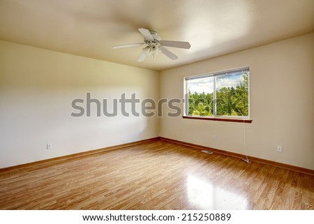 Spacious empty room with window and new hardwood floor