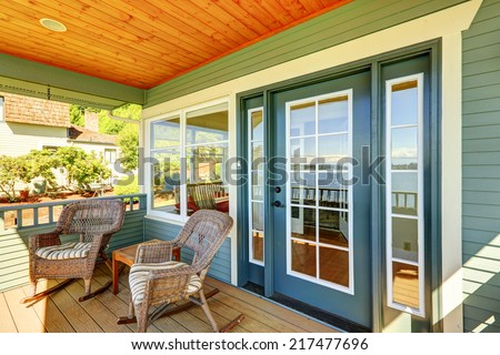 Cozy walkout deck with wicker rocking chairs and small coffee table