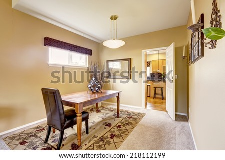 Dining room interior design. Simple wooden table with leather chair on beige rug