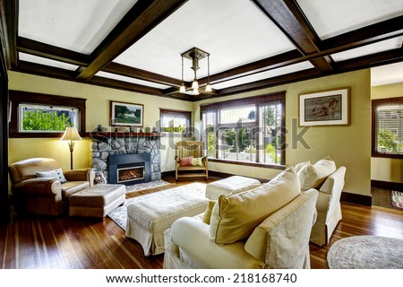 Living room design idea. Coffered ceiling blend with stone trim fireplace and rustic rocking bench