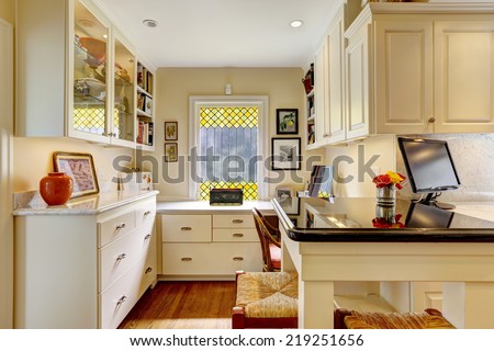 Cozy office area with white cabinets in kitchen room