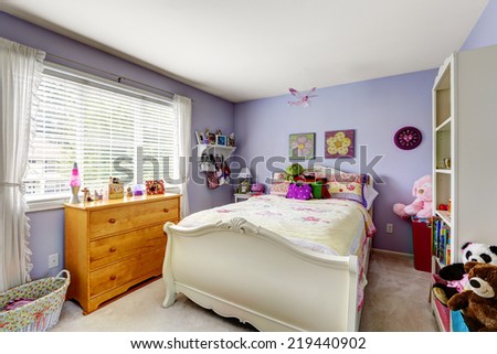 Purple room with white single bed and toys.