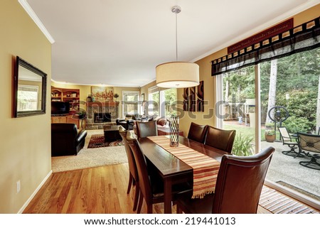 Dining area with family dining table set. Exit to backyard patio. Living room with fireplace