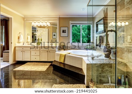 Luxury bathroom interior with corner bath tub and glass transparent shower