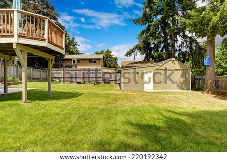 Spacious fenced backyard with shed