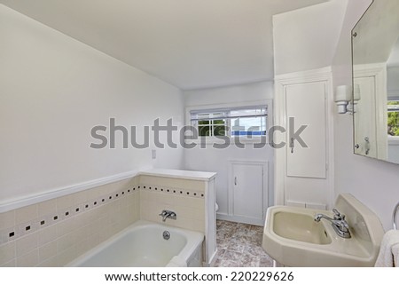 White bathroom interior with small window. Old house interior.