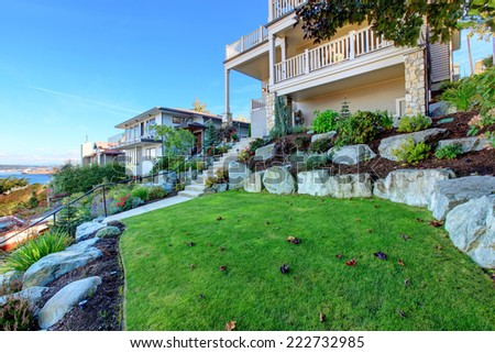 Leveled landscape design with rocks and flowers, bushes and trees. Real estate in Tacoma, WA
