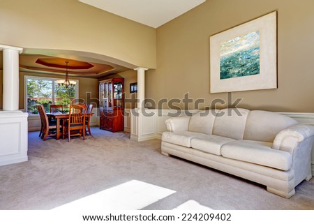 Luxury house exterior with white columns and light olive walls. Living room with dining area
