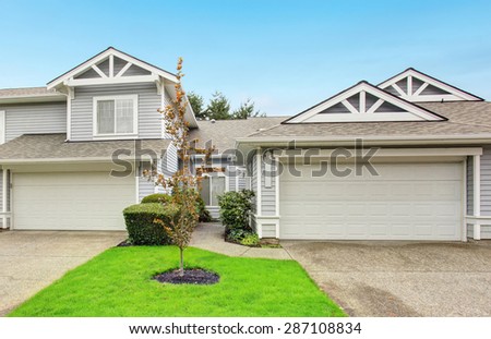 Modern northwest home with garage and grass yard.