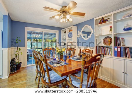 Beautifully decorated dinning room with sliding glass door and dinning set.