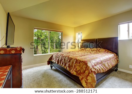 Master bedroom with carpet, windows, and king sized bed.