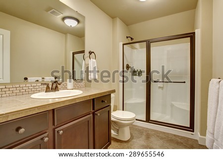 Elegant bathroom with tile floor, and glass shower.
