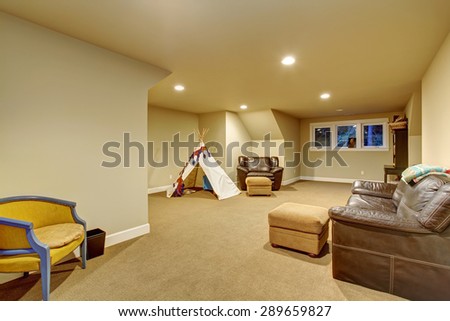 Large kids play room with carpet, and windows.