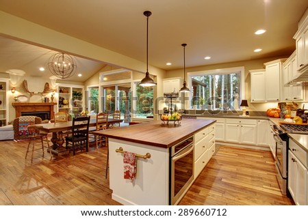 Classic kitchen with hardwood floor, an island, and connected dinning room.