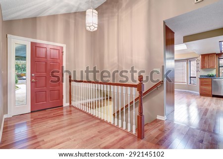 simple entry way with hardwood floor and staircase.
