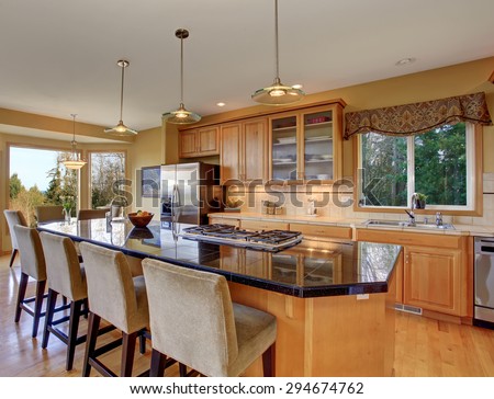 Gorgeous kitchen in perfect traditional home, with large island and light toned hardwood floor.