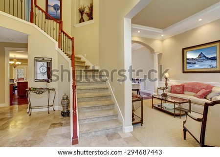 Beautiful entry way with staircase and front room.