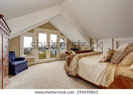 refined master bedroom with carpet, nice bedding, and balcony