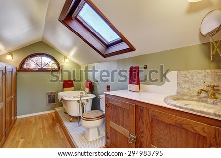 Vintage bathroom with marble sink, and vaulted ceiling.
