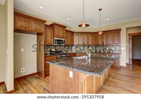 Lovely kitchen with bar island, and hardwood floor.