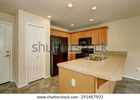 Small kitchen with tile floor and a pantry.