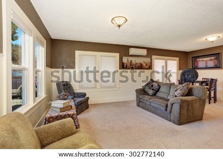 Simple secondary living room with brown and white interior paint job.