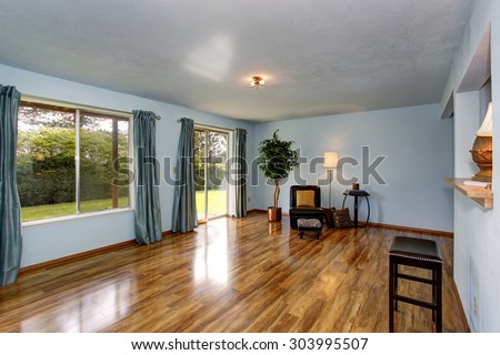 Secondary living room with hardwood floor, sliding glass door, and blue interior.