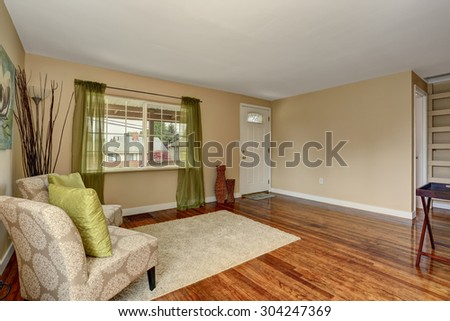 Lovely hardwood floor room with green and blue decor.