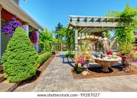 Backyard with outdoor living room and green trees.