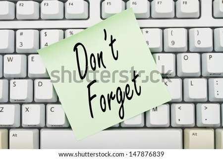 Computer keyboard keys with sticky note with words Don\'t Forget, Reminder of what to do