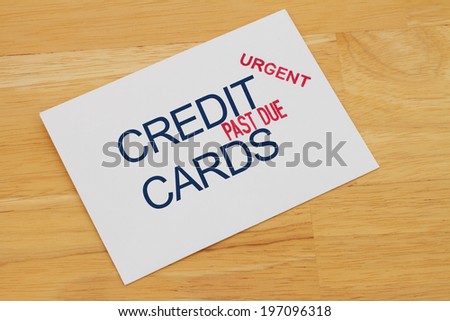 Credit Card Payment envelop with past due and urgent stamps on a wooden desk