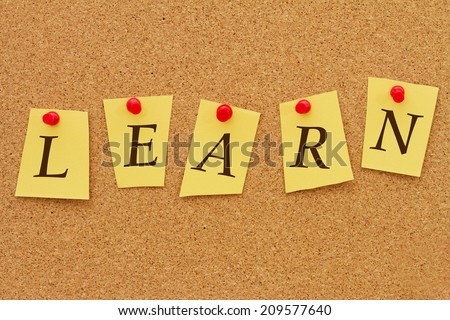 Learn Notice, Four yellow notes on a cork board with the word Learn