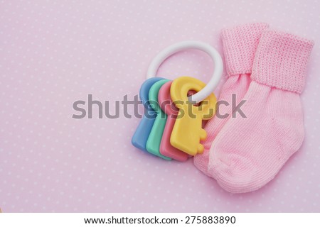 Pink Baby Background, Pink baby socks with soother on pink and white polka dot background with copy-space for your message