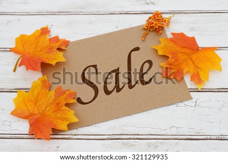 Autumn Sale Card, A brown card with words Autumn Sale over a distressed wood background with Autumn Leaves