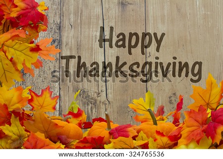 Happy Thanksgiving, Autumn Leaves and Pumpkins with grunge wood background with text Happy Thanksgiving