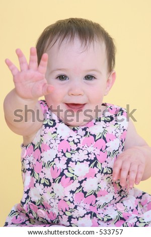 girl smiling and waving hello