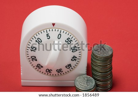 close-up of egg timer running out of time with quarters