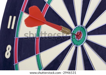 Dart board with dart in the center - bulls eye