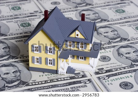 Two-story house with five dollar bills background