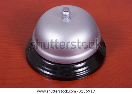 Service bell with a cherry wood background