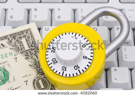 A combination lock with money on a keyboard
