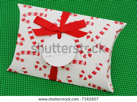 Gift with blank gift tag green background