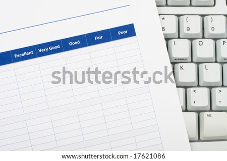 Close up of survey with computer keyboard, excellent customer service